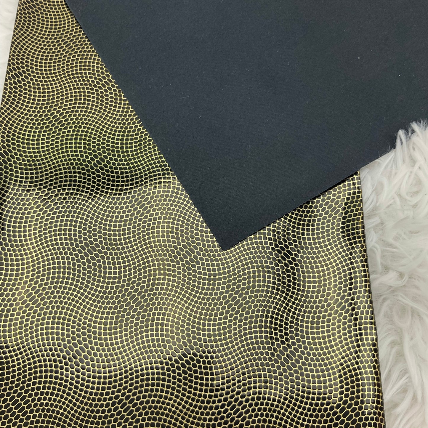 Gold and Black Embossed Pebbles Glossy Faux Leather